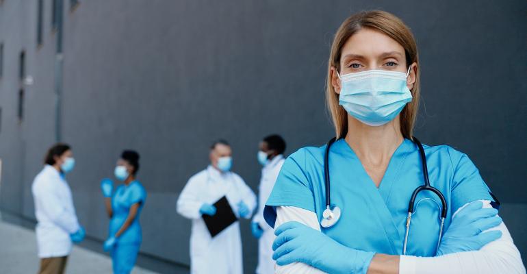 female-doctor-in-mask-with-arms-folded.jpg